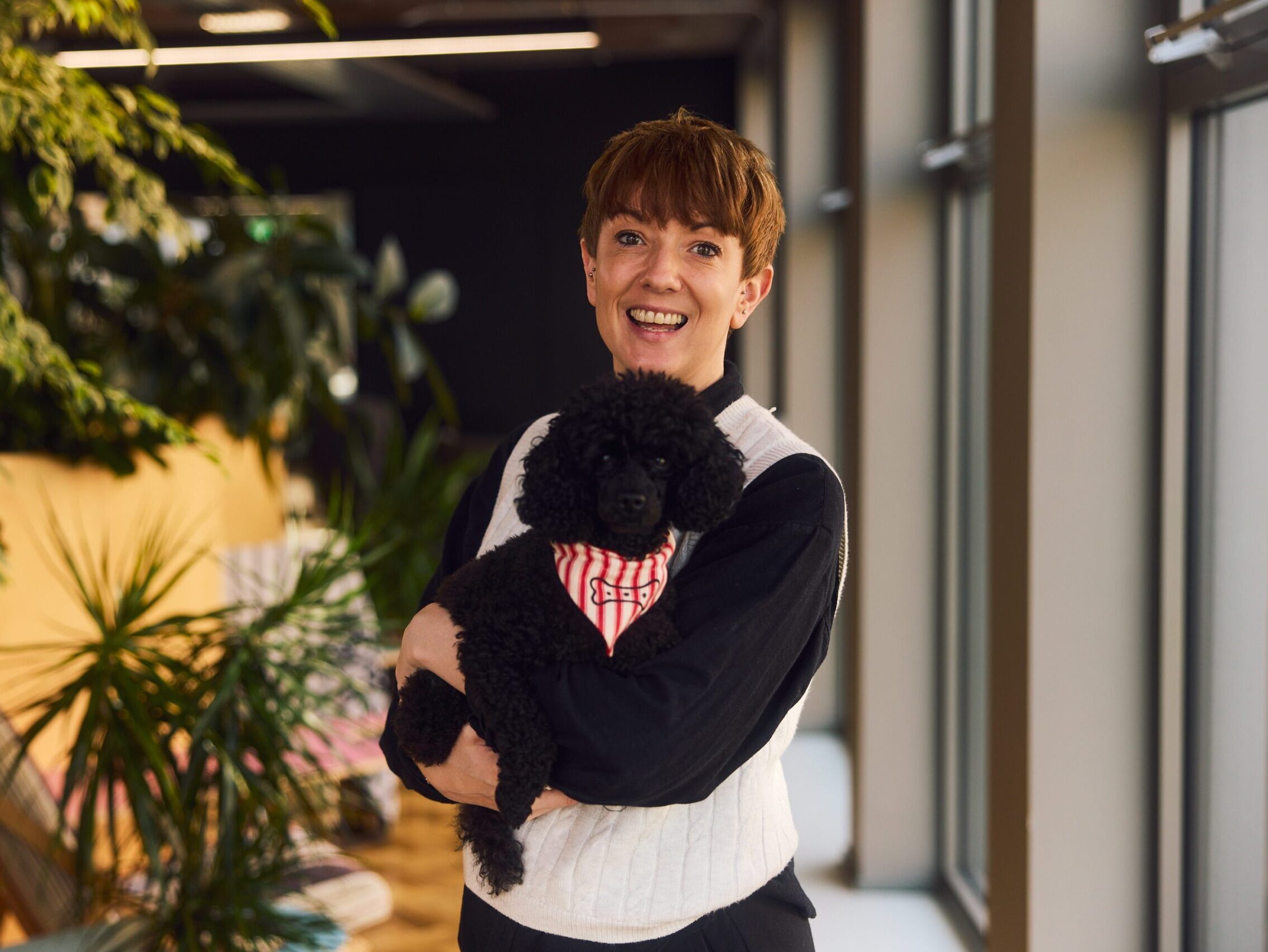 Jolle Kirkham holding black toy poodle