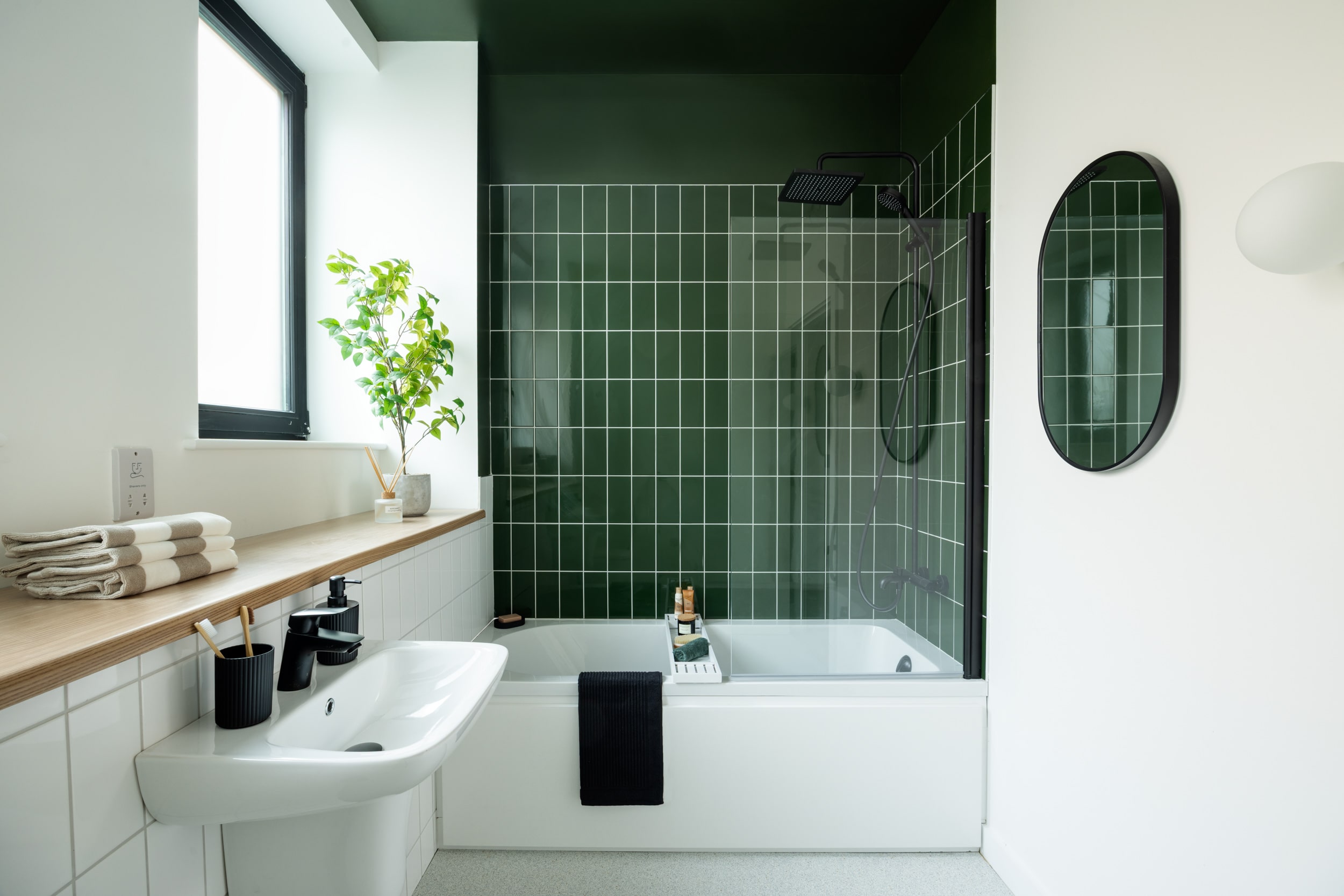 Centric Showroom bathroom with forest green tiles and minimalist features