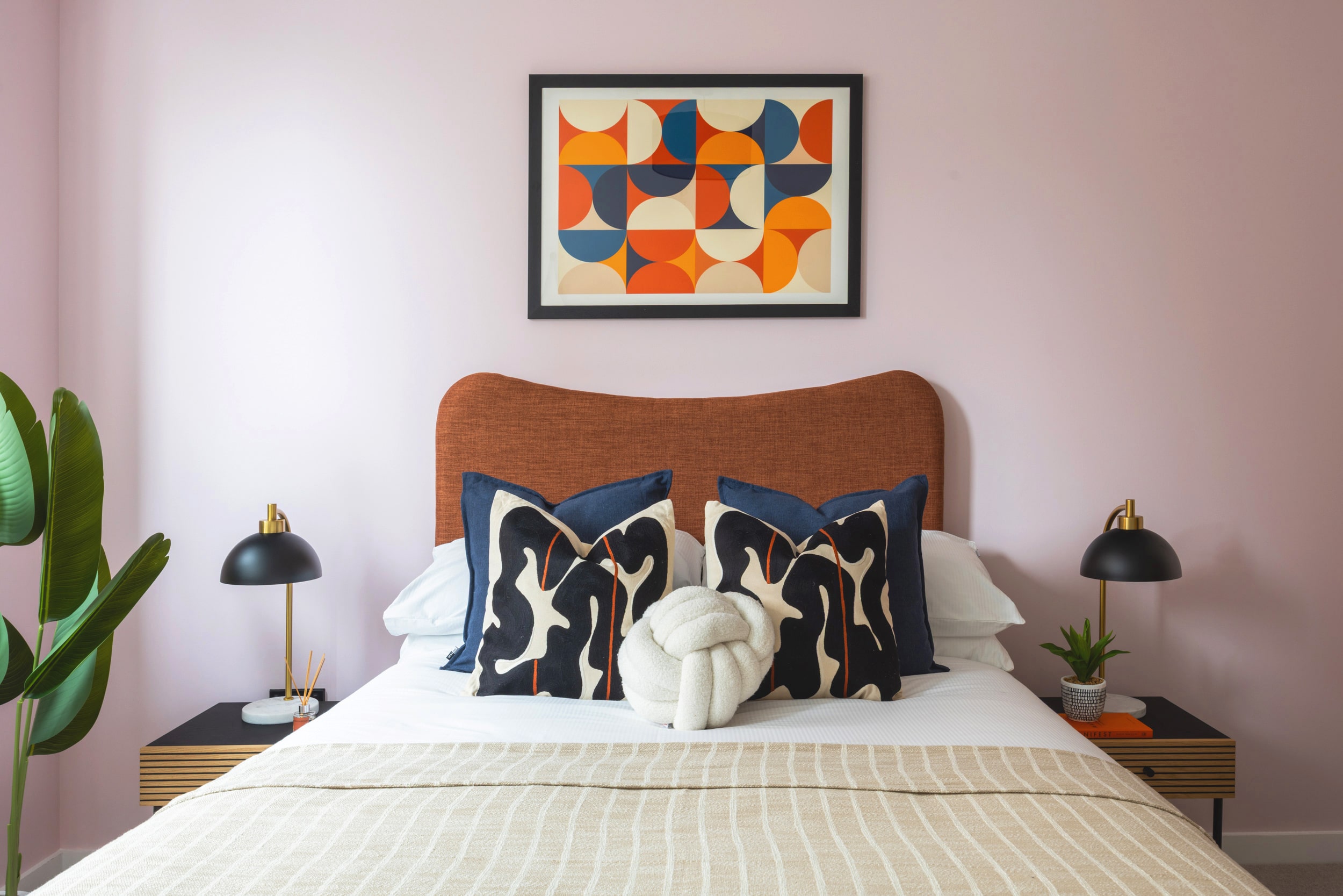 Centric showroom bedroom, featuring baby pink wall and asthetically pleasing decor